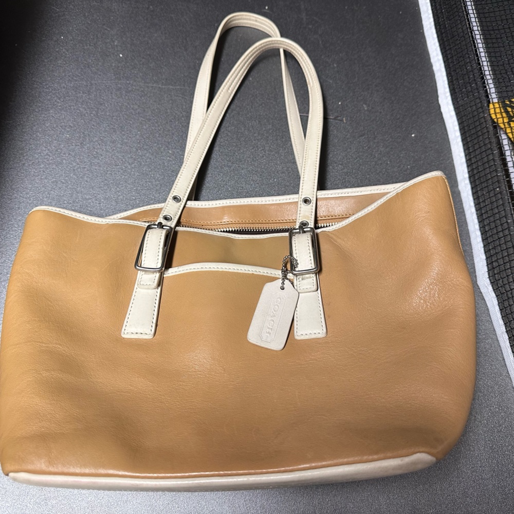 This is an authentic Coach purse. No rips or tears. A few marks on the bottom.